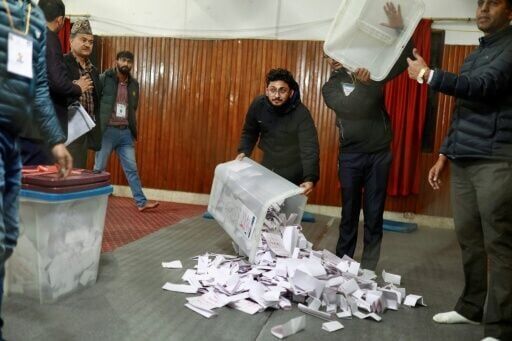 Election officials empty ballot boxes to begin counting in the capital