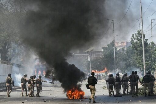 Security personnel fire tear gas as Shiite Muslims shout slogans during a protest outside the US consulate in Karachi after the death of Iran's supreme leader Ayatollah Ali Khamenei amid US-Israel strikes