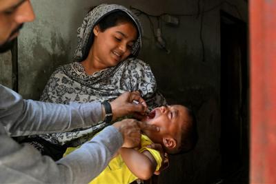In Pakistan, where wild polio still has not been eliminated, health workers go door to door vaccinating young children.