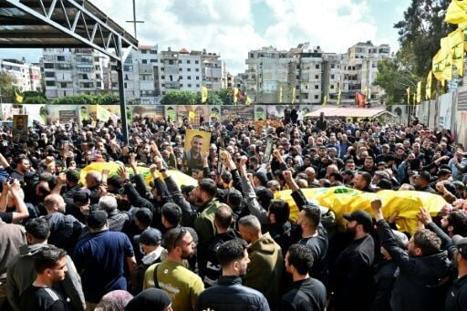 Mourners carry the flag-draped caskets of members of the Iran-backed militant group Hezbollah who were killed in southern Lebanon