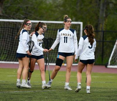 Players from the Eagles girls lacrosse team celebrate a goal earlier this year