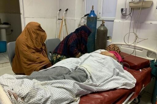 A wounded Afghan woman receives treatment at a hospital in Jalalabad after an overnight Pakistani mortar shell hit a camp for people returning from Pakistan