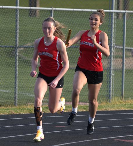Dufur junior Hailee Pechanec passes the baton to sophomore Jacey Calloway earlier this year in White Salmon.