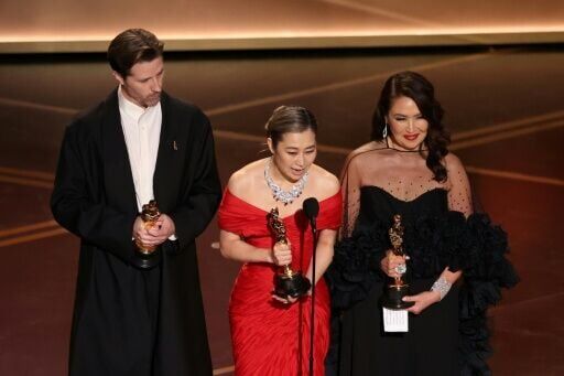 Co-director Chris Appelhans co-director Maggie Kang and producer Michelle Wong accept the Oscar for best animated feature for 'KPop Demon Hunters'