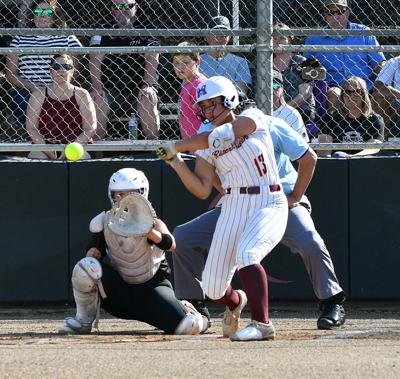 Riverhawk senior Maddy Sagapolutele (13) swings at a pitch May 27 in The Dalles.