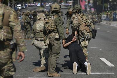 Police detain a man during a June 2025 protest in Paramount, Calif., where federal immigration authorities had conducted operations.