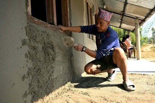 Father-of-four Dipak Magar rushes to plaster his house before returning to work in Saudi Arabia