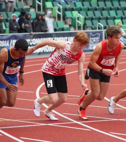 Horizon Christian’s Josh Carley (center) and Dufur’s Zeb Stelzer break at the start of the 1500-meter run at the 2026 OSAA Class 1A state track and field meet at historic Hayward Field in Eugene May 29. Both runners raced to personal bests at state.