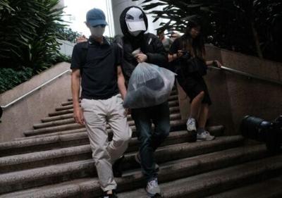 Kwok Yin-sang (L) leaves the High Court after a judge granted him bail in Hong Kong on May 20, 2025. He has been convicted of handling money belonging to his daughter, a wanted pro-democracy activist based overseas, in the first such verdict issued unde...
