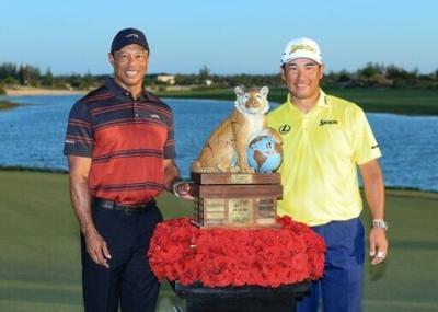 Hero World Challenge winner Hideki Matsuyama of Japan is presented with the trophy by tournament host Tiger Woods