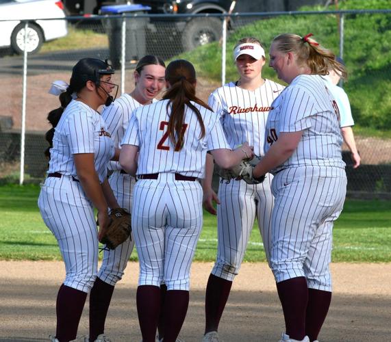 The Dalles/Dufur High School softball team meets before a game earlier this year.