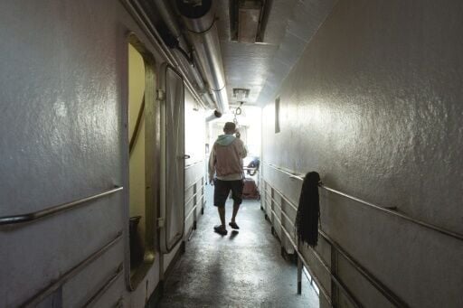 Indonesian national Surono, a crew member of the tuna longliner fishing vessel Novo Ruivo, walks in a passageway at the Porto Grande port in Mindelo