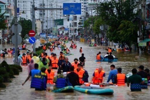 People wade through floodwaters in Vietnam's coastal Nha Trang city