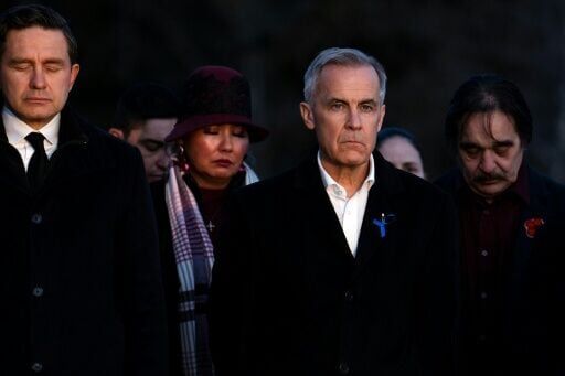 Prime Minister Mark Carney (R) and the leader of the Conservative Party Pierre Poilievre (L) observe a moment of silence to honor the victims of one of Canada’s deadliest shootings