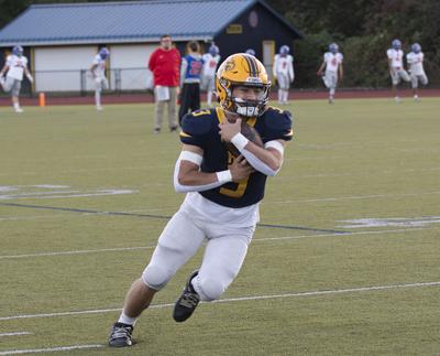 Bam Layna (3) tucks the ball during warm-ups for Hood River Valley football before a game earlier this year.  Zach Thummel photo