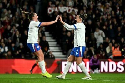 England's Lucy Bronze (R) celebrates scoring against Australia