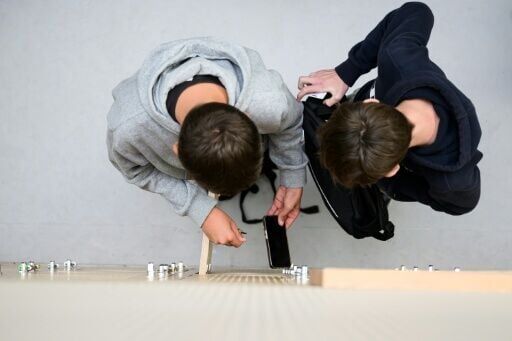 Students place their phones in lockers after switching them off at a highschool in Lorient