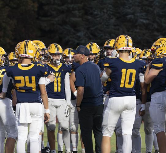 Hood River Valley football head coach Caleb Sperry gets his team ready before the game against La Salle on Oct. 3