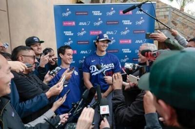 Shohei Ohtani of the Los Angeles Dodgers speaks to the media during spring training workouts in Arizona