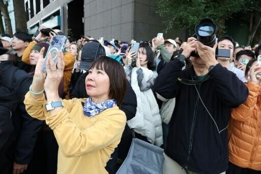 At one point, he stepped onto a platform midway up to wave down at fans and onlookers who were taking photos