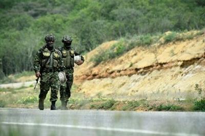 Colombian soldiers take part in an operation to deactivate gas cylinders allegedly loaded with explosives by the ELN on a road near Cucuta, department of Norte de Santander, Colombia, on December 15, 2025