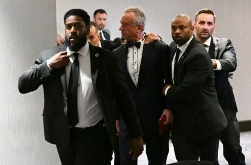 US Secretary of Health and Human Services Robert F Kennedy Jr is rushed out by Secret Service agents after loud bangs were heard during the White House Correspondents Association dinner at the Washington Hilton
