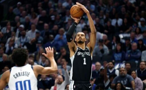 San Antonio star Victor Wembanyama shoots over Max Christie in the Spurs' NBA victory over the Dallas Mavericks