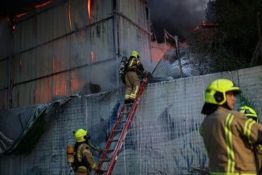 Israeli firefighters battled a fire after a strike on the outskirts of Tel Aviv