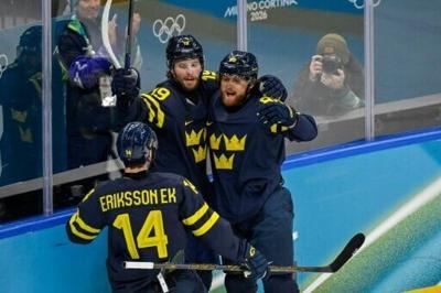 Sweden's Adrian Kempe (C) scored their first goal in a 5-1 win against Latvia to move into the Olympic men's ice hockey quarter-finals