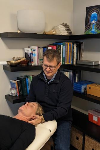 Tucker Meager, ND, practices craniosacral therapy on a patient. Photo courtesy of Tucker Meager.