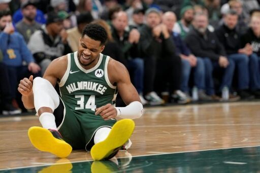 Giannis Antetokounmpo of the Milwaukee Bucks reacts after suffering a non-contact injury in the team's NBA win over the Detroit Pistons