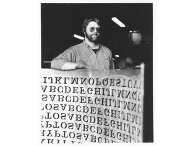 This 1990 handout photo, courtesy of Jim Sanborn, shows sculptor Jim Sanborn with a cut of his 'Kryptos' copper sculpture