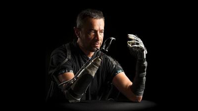 Samoana (Sam) Matagi demonstrates an AI-driven robotic hand that allows greater dexterity.