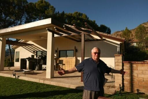 Ted Koerner poses in front of his brand new house on December 29, 2025, rebuilt less than a year after the fire that destroyed Altadena