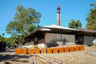 Coffins are prepared at a cemetery for victims of a Myanmar military air strike at a hospital