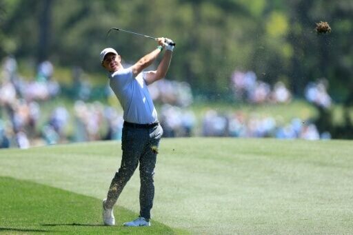 Defending champion Rory McIlroy of Northern Ireland battled England's Justin Rose and Tyrrell Hatton for the lead in the second round of the 90th Masters
