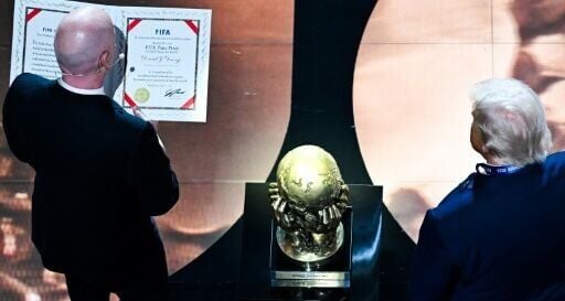 FIFA President Gianni Infantino presents the newly-created FIFA Peace Prize to US President Donald Trump at the World Cup draw