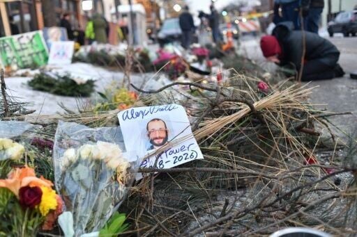 Mourners gather at a makeshift memorial in the area where Alex Pretti was shot dead in a confrontation that has become a political falshpoint