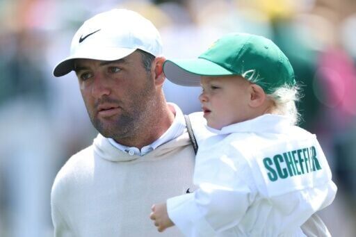 Top-ranked Scottie Scheffler, a four-time major winner from the United States, carries his son Bennett during the Masters Par-Three Contest at Augusta National