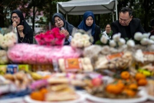 Indonesians in Hong Kong take part in a vigil for victims of the deadly fire