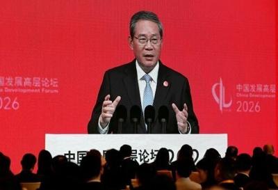 Chinese Premier Li Qiang seen on a big screen live broadcasting his speech at the opening of the China Development Forum