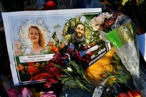 A card with images of Renée Good and Alex Pretti, both 37, lies among flowers and other mementos at a memorial in Minneapolis