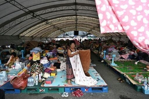 Displaced residents rest at an evacuation centre at Chang International Circuit in the Thai border province of Buriram