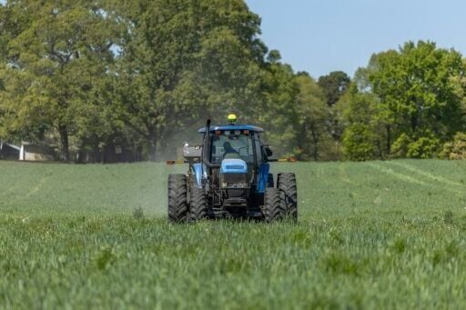 Fertilizer is spread across a field in North Carolina, where Andy Corriher farms