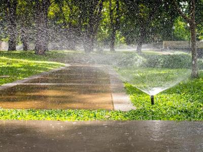 09-23 soil and water conservation story sprinkler-watering-pavement.jpg