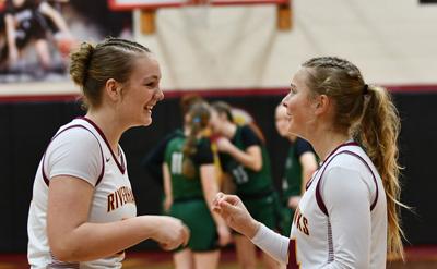 Evelyn Rogers (23) and Willow Ziegenhagen (14) meet during starting lineups against Estacada earlier this year.