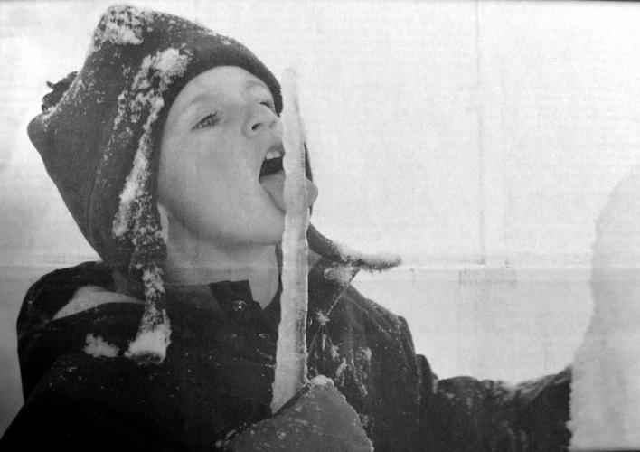 FROZEN IN TIME: Sawyer Bogard taste tests an icicle last week while carousing around in the snow. Photo taken by Sawyer’s father, Clint Bogard. — Jan. 21, 2004, Hood River News