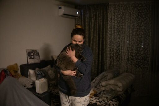 Tetyana Kolisnichenko, in her Soviet-era block, has been filling plastic bottles with hot water to keep warm