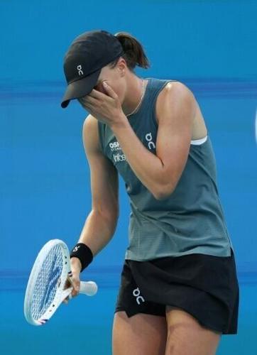 Second-seeded Iga Swiatek is out of the Miami Open after falling in her second-round opener to Polish compatriot Magda Linette