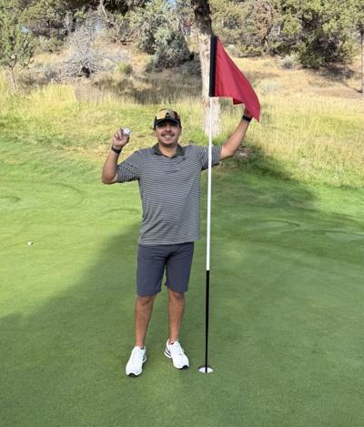 AJ Valencia stands with his hole in one shot at the Eaglecrest Resort Course on Saturday, August 1.